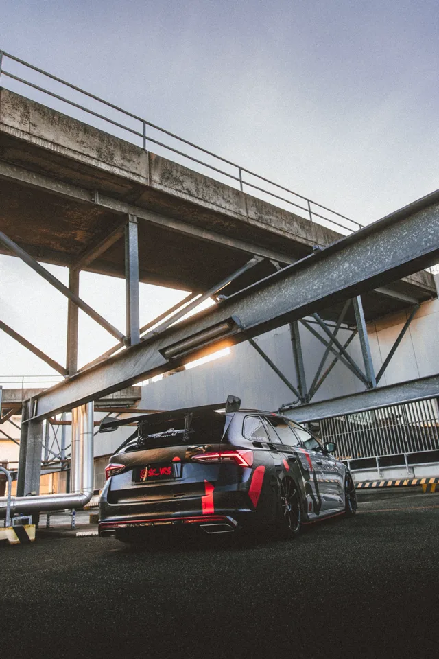 Rear three-quarter view of the Octavia RS beneath industrial beams