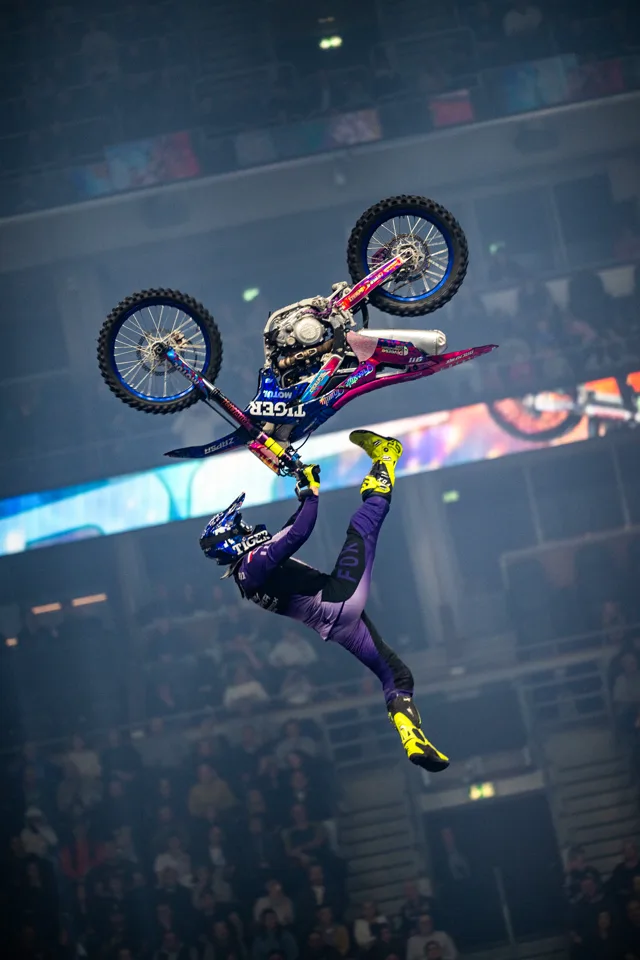 ZAPSA performing a freestyle motocross trick high above an indoor arena